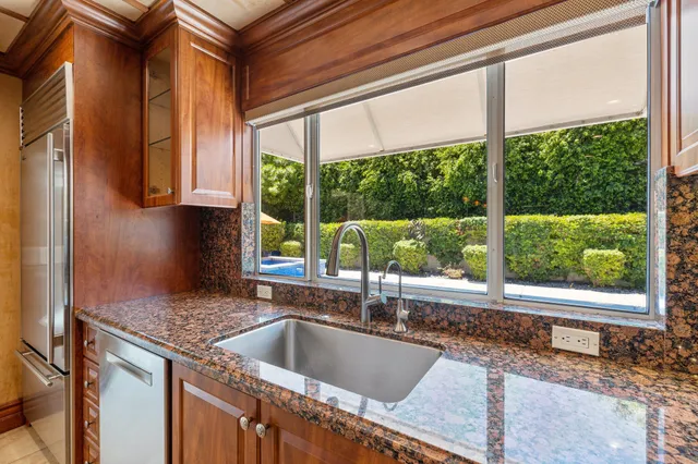 a kitchen sink sitting next to a window