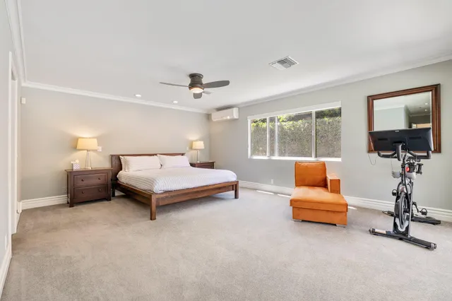 a bedroom with furniture and a lamp