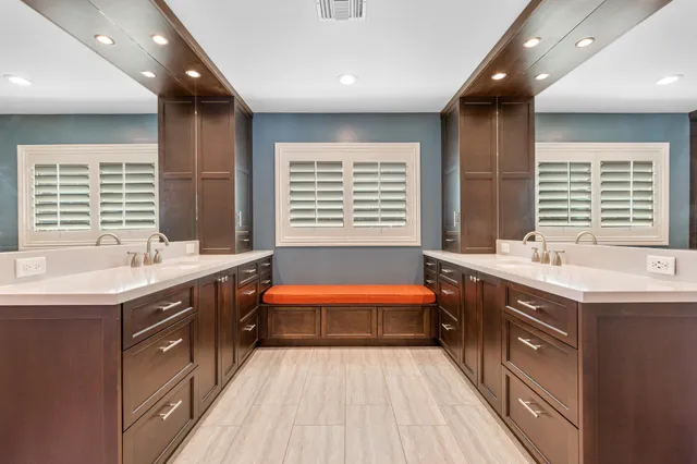 a large kitchen with a large counter top and sink