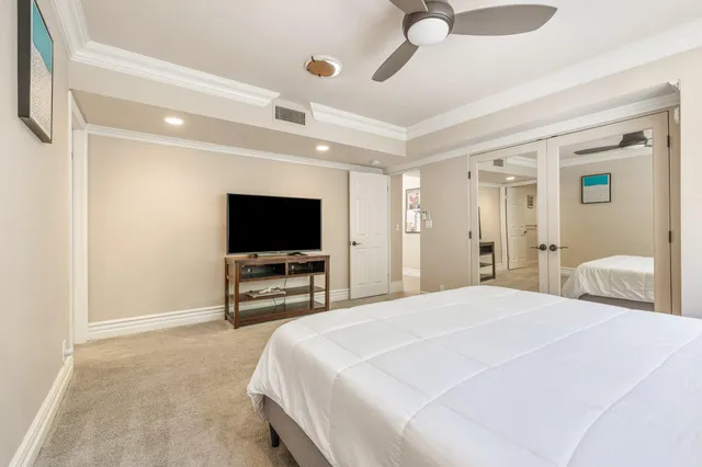 a bedroom with a bed and a flat screen tv