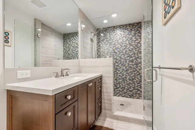 a bathroom with a sink a toilet and shower