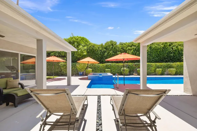 a view of an outdoor dining space with a table and chairs
