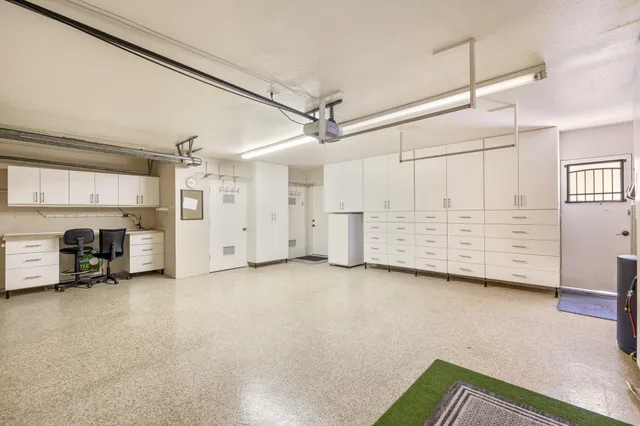 a view of an empty room with furniture and a kitchen