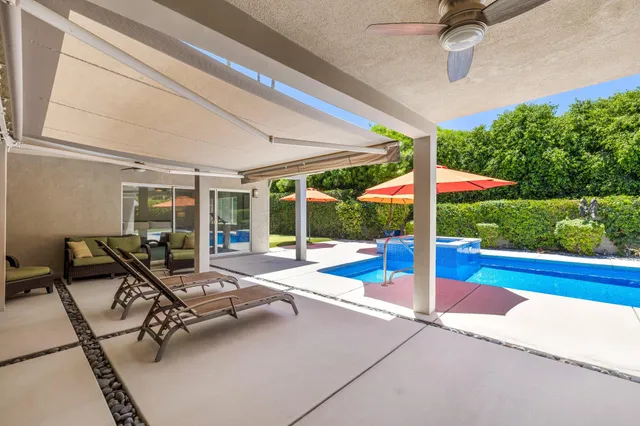 a building outdoor space with patio furniture and garden