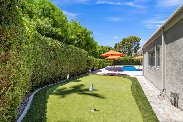 a view of a swimming pool with a yard