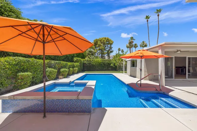 a view of a swimming pool with a lounge chairs