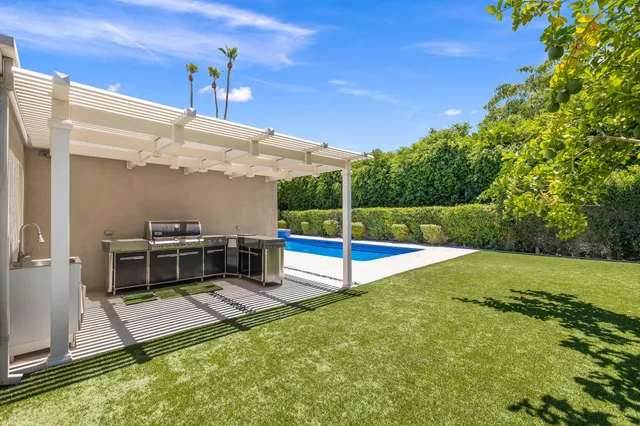 a view of a backyard with swimming pool