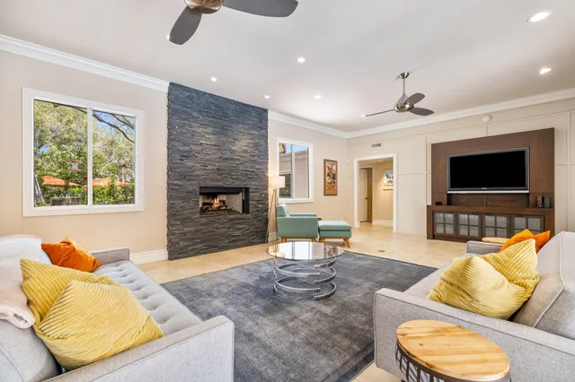 a living room with furniture flat screen tv and a fireplace