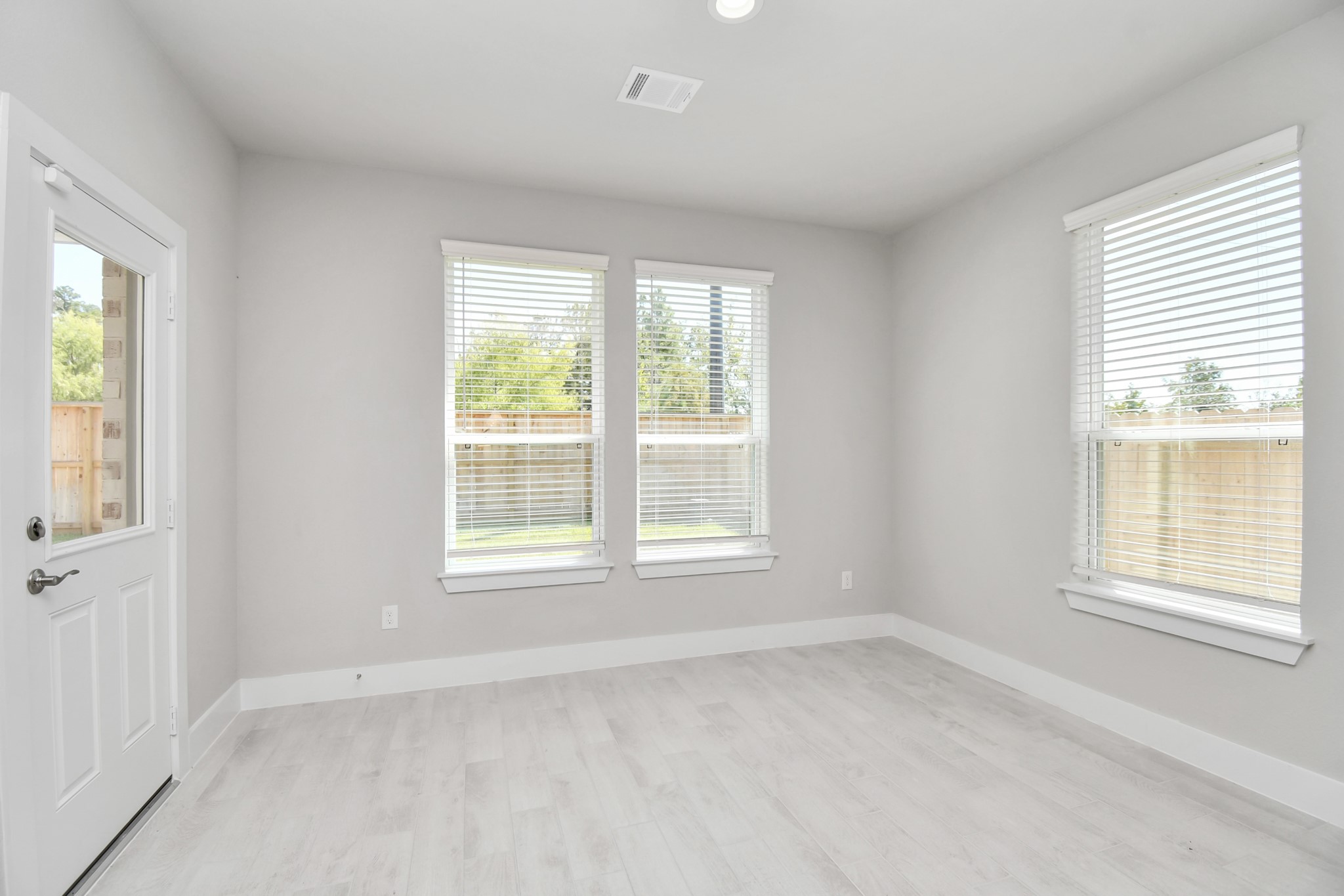 3106 Skerne Spring Dr Spring Spring, TX 77373 - Photo 18 of 47 Enjoy breakfast with ease in the connected and cozy breakfast area, seamlessly integrated with the kitchen for utmost convenience. Step through the back door for a breath of fresh air onto the covered patio, extending your living space to the outdoors