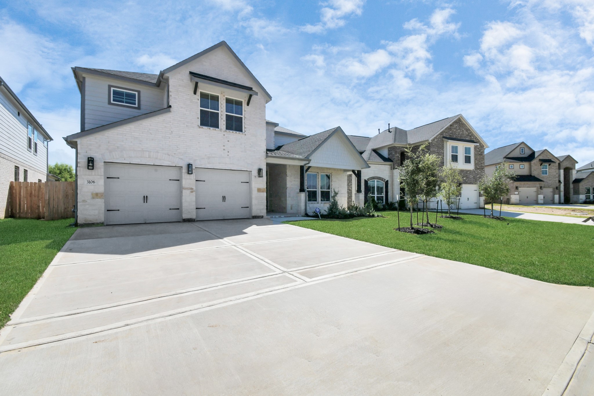 3106 Skerne Spring Dr Spring Spring, TX 77373 - Photo 2 of 47 The residence features a practical 2-car garage complemented by a generous driveway, ensuring abundant space for parking needs.