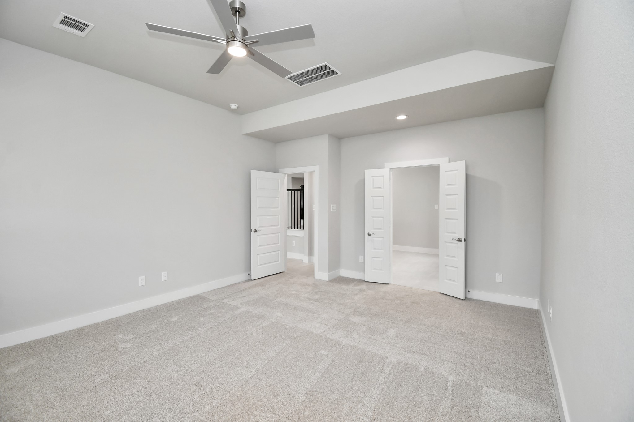 3106 Skerne Spring Dr Spring Spring, TX 77373 - Photo 23 of 47 Retreat to the luxurious primary suite, your perfect escape for unwinding after a long day. Located on the first floor, this spacious room features plush carpeting, calming paint tones, high ceilings, and large windows with privacy blinds.