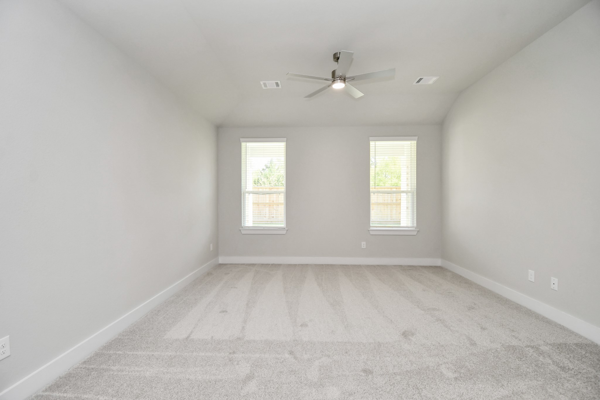 3106 Skerne Spring Dr Spring Spring, TX 77373 - Photo 26 of 47 Escape to tranquility in this spacious primary room, adorned with plush carpeting and bathed in the soothing hues of warm paint colors, creating a cozy retreat for relaxation.