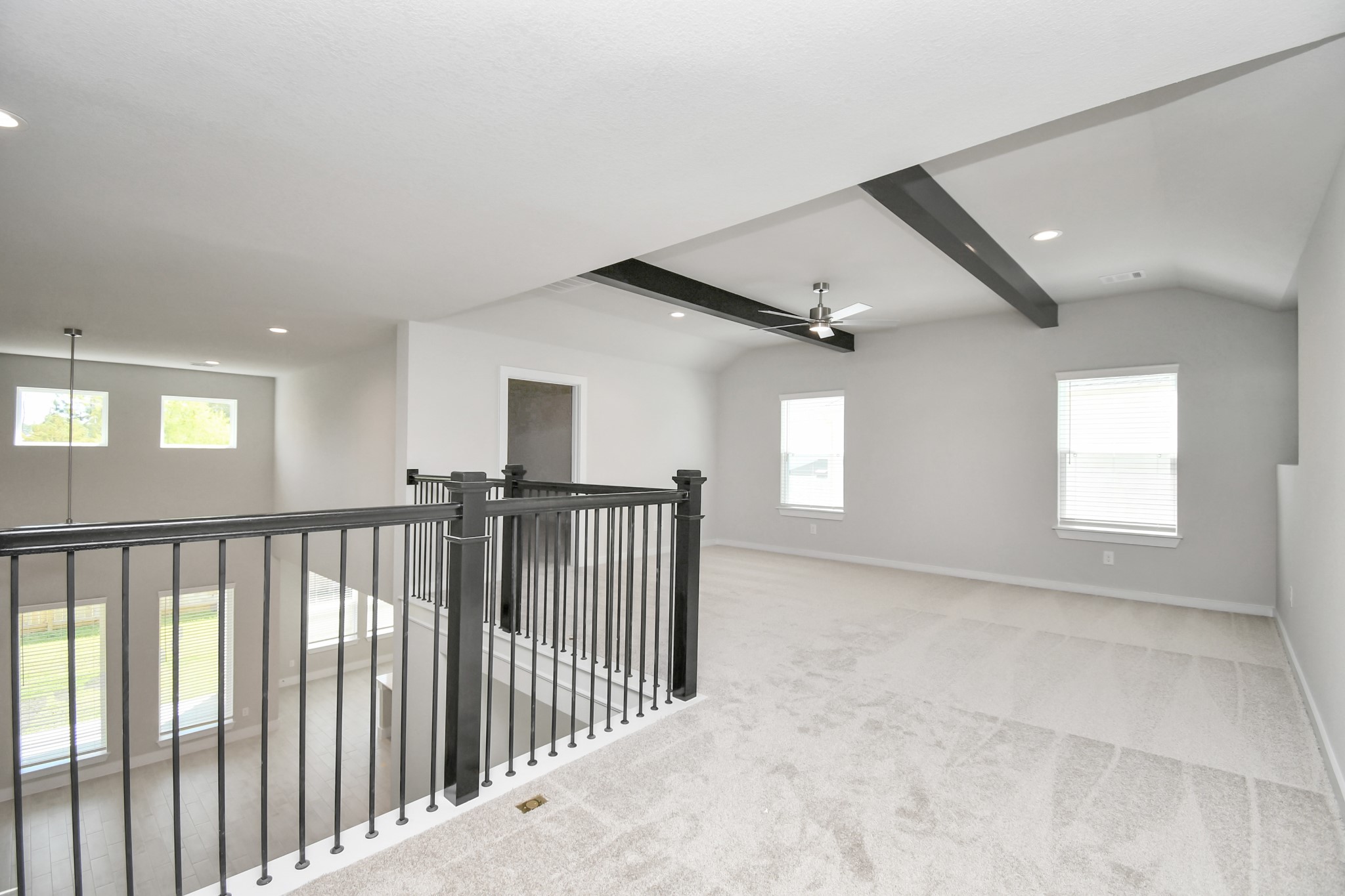 3106 Skerne Spring Dr Spring Spring, TX 77373 - Photo 33 of 47 Discover a haven of leisure in this fantastic game room! Whether you're seeking a casual hangout or an adult gaming retreat, this space has it all. Enjoy the luxurious feel of plush carpet underfoot, the expansive ambiance of high ceilings, custom paint that adds a touch of personality, and windows that flood the room with refreshing natural light.