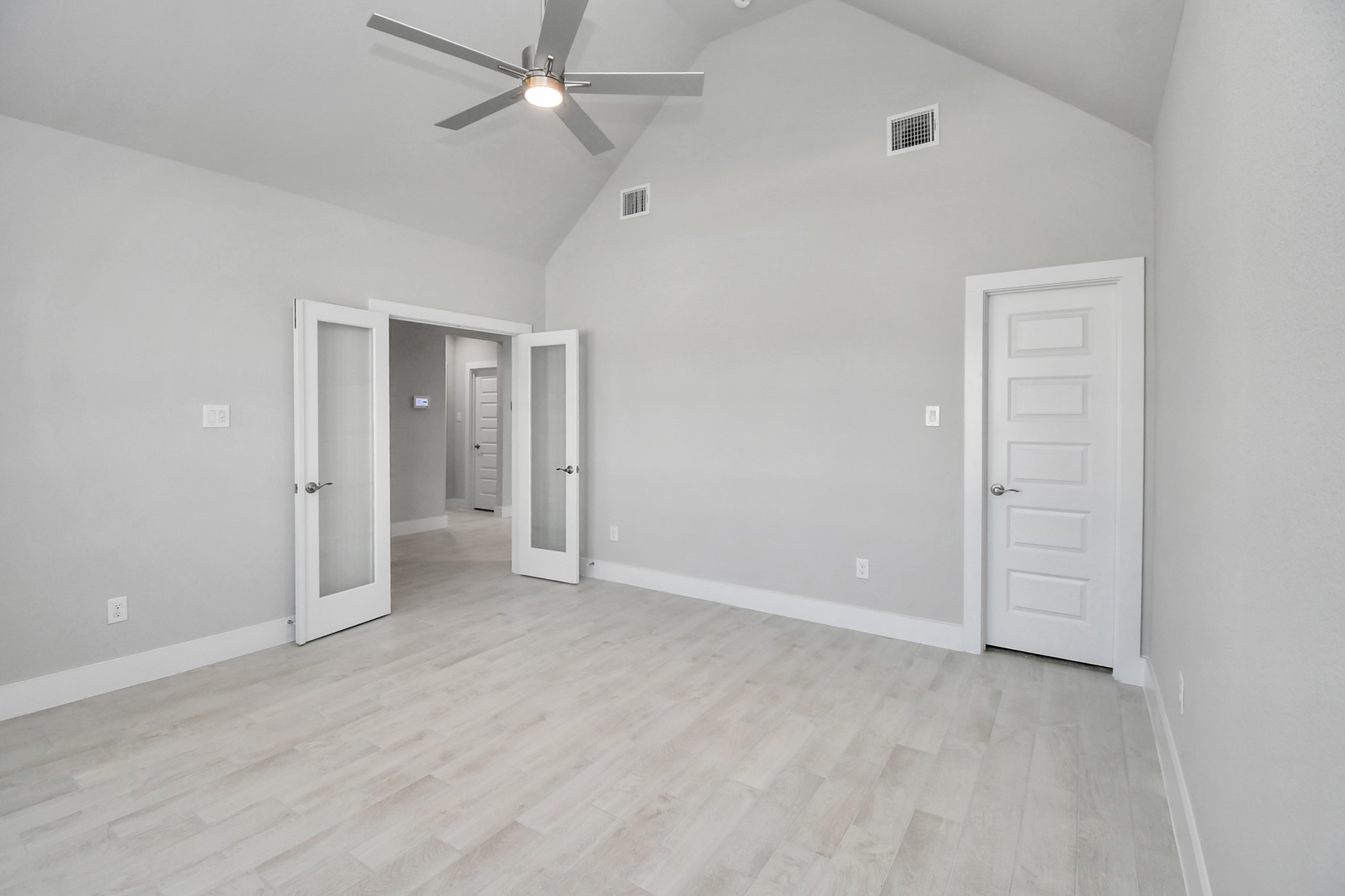 3106 Skerne Spring Dr Spring Spring, TX 77373 - Photo 6 of 47 Experience the perfect blend of sophistication and warmth in this home office, boasting elegant wood-look tile flooring and flooded with natural light from expansive windows and French doors.