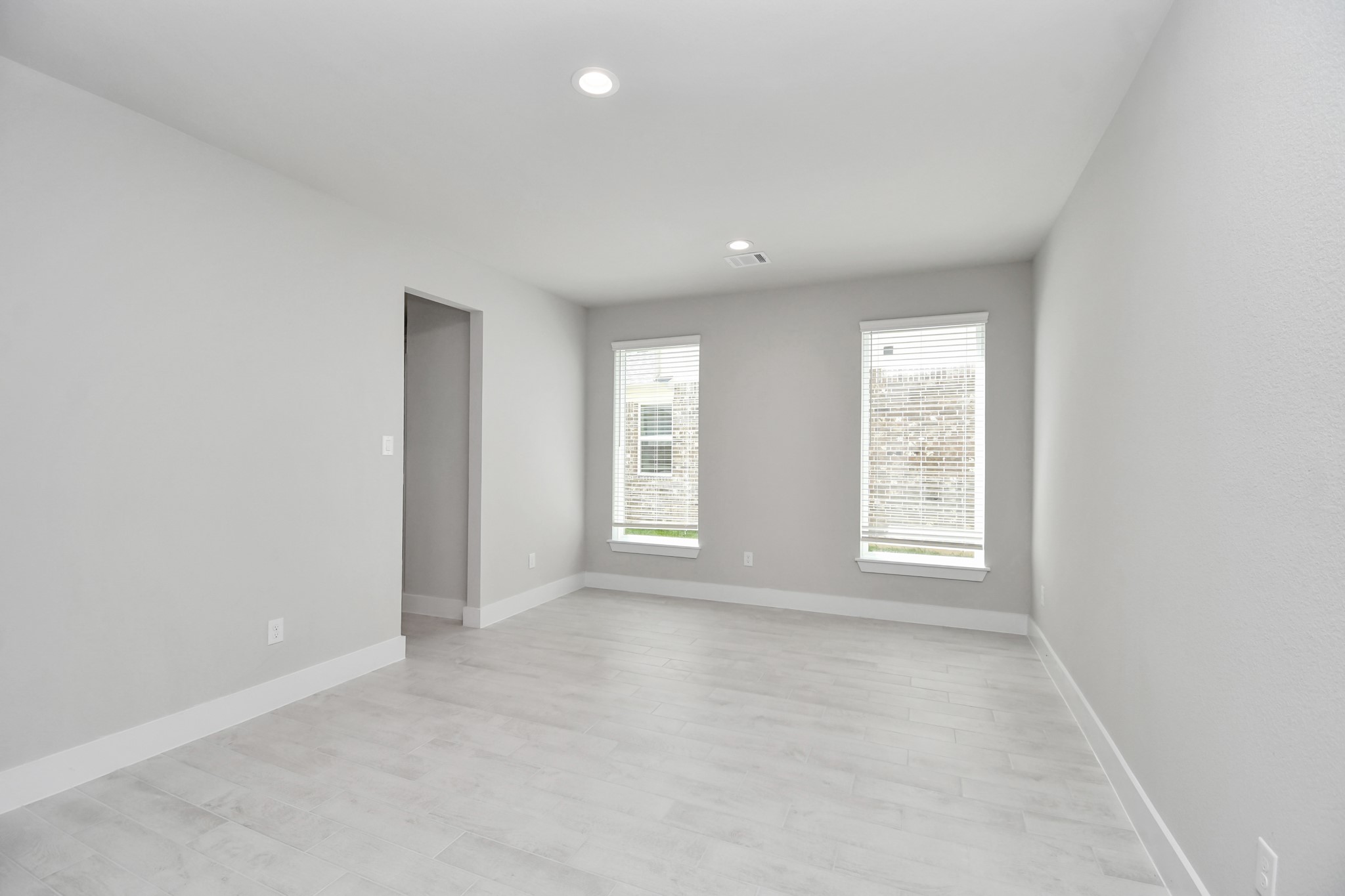 3106 Skerne Spring Dr Spring Spring, TX 77373 - Photo 10 of 47 Create lasting memories with your family and friends at the dining table! This expansive dining room showcases sophisticated flooring, custom paint, and seamlessly connects to the family room and kitchen, providing an open and inviting atmosphere