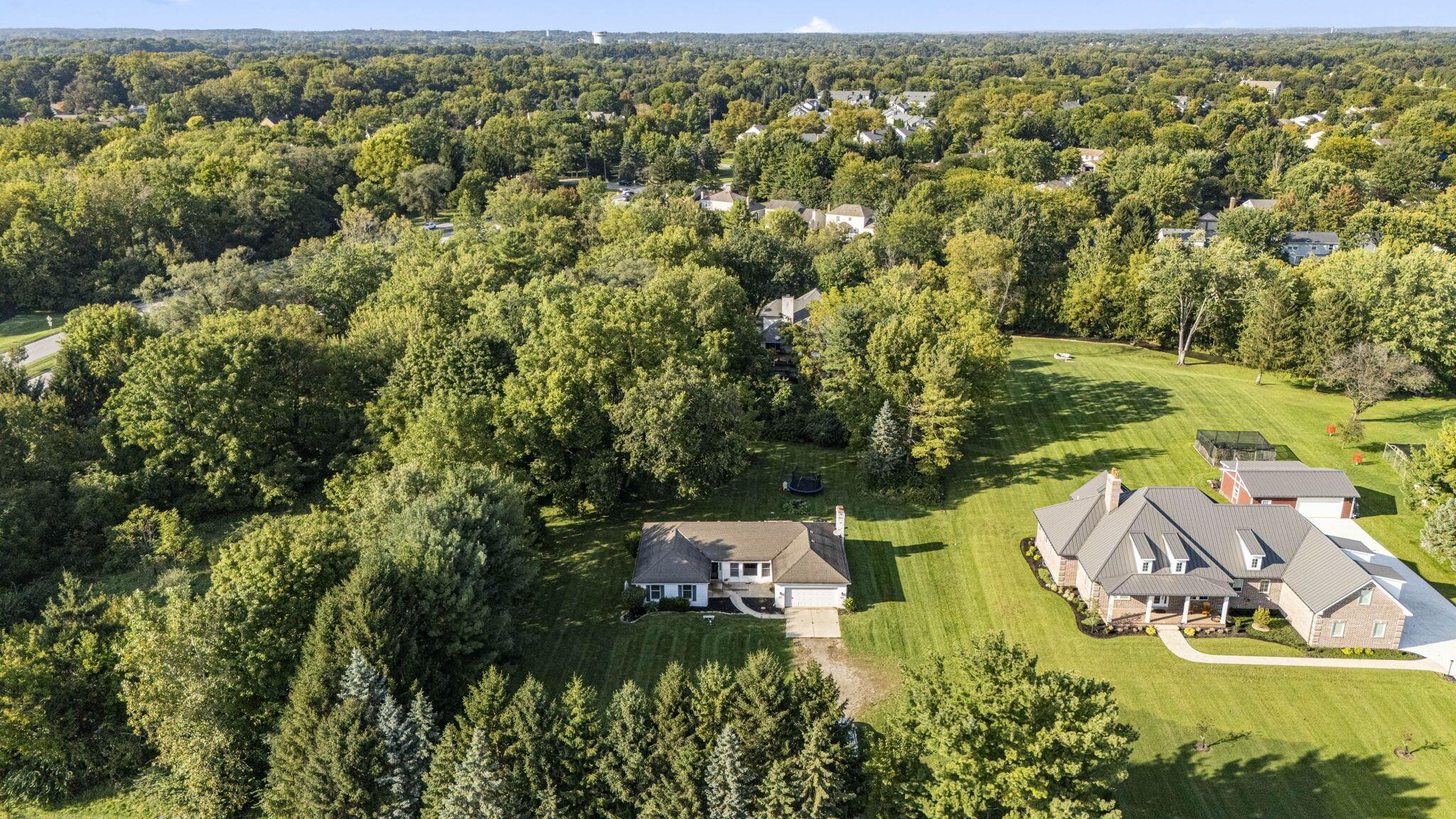 6344 Post Road Dublin, OH 43017 - Photo 36 of 45 Expansive property featuring two distinct residences, a detached garage, and substantial green space with mature trees