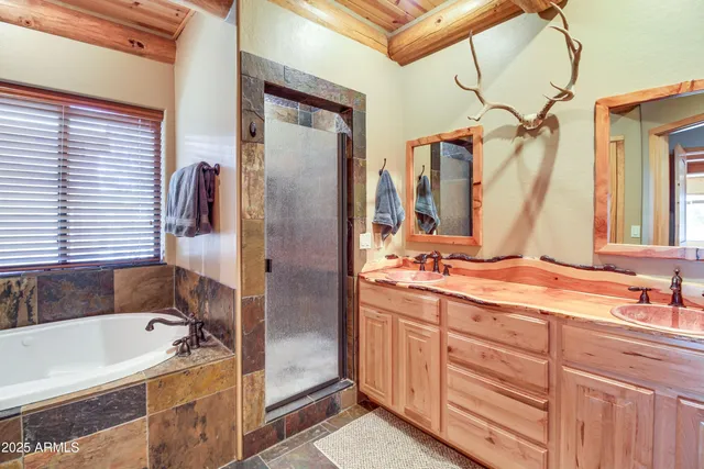 a bathroom with a tub sink and mirror