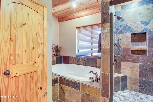 a bathroom with a tub and shower