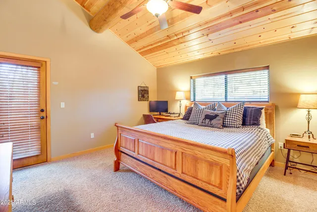 a bed sitting in a bedroom next to a window