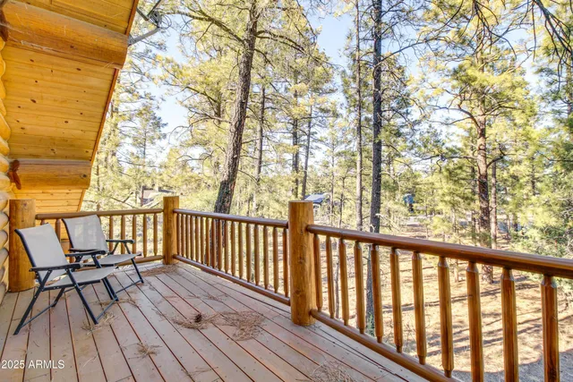 a view of balcony with wooden floor and fence