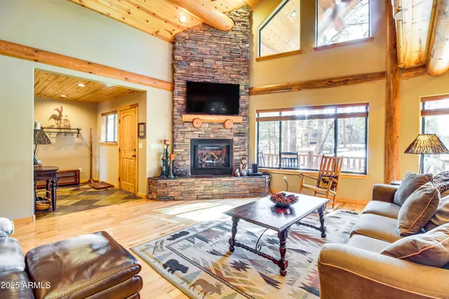 a living room with furniture a fireplace and a flat screen tv
