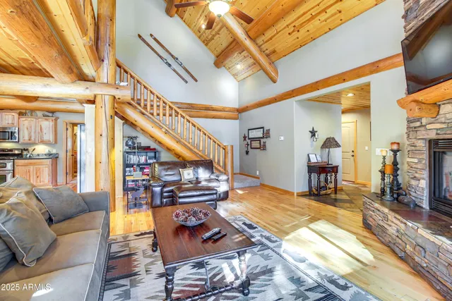 a living room with furniture a rug and a chandelier