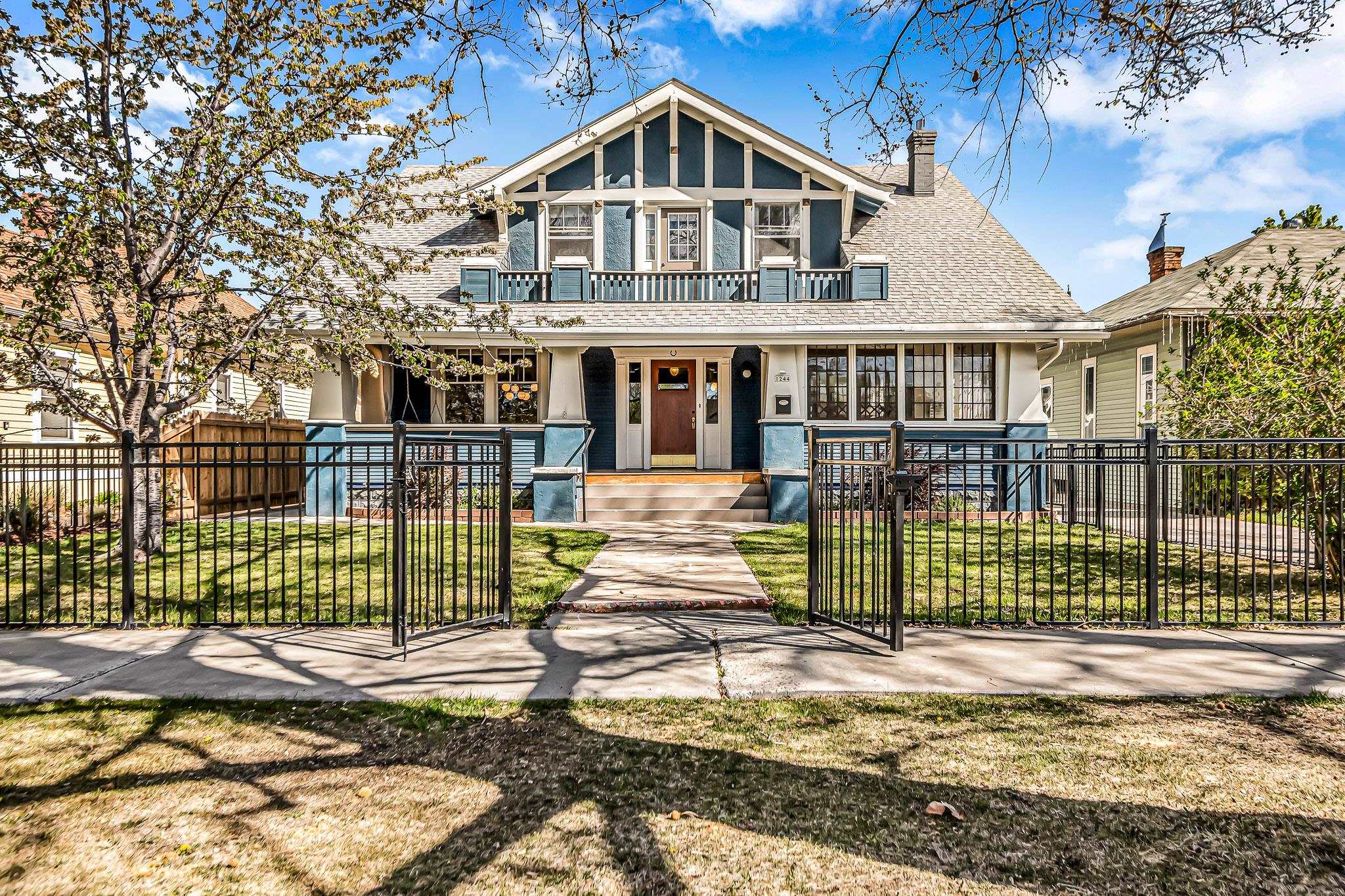 1244 Main Street Grand Junction, CO 81501 - Photo 1 of 33 a front view of a house with a garden and plants