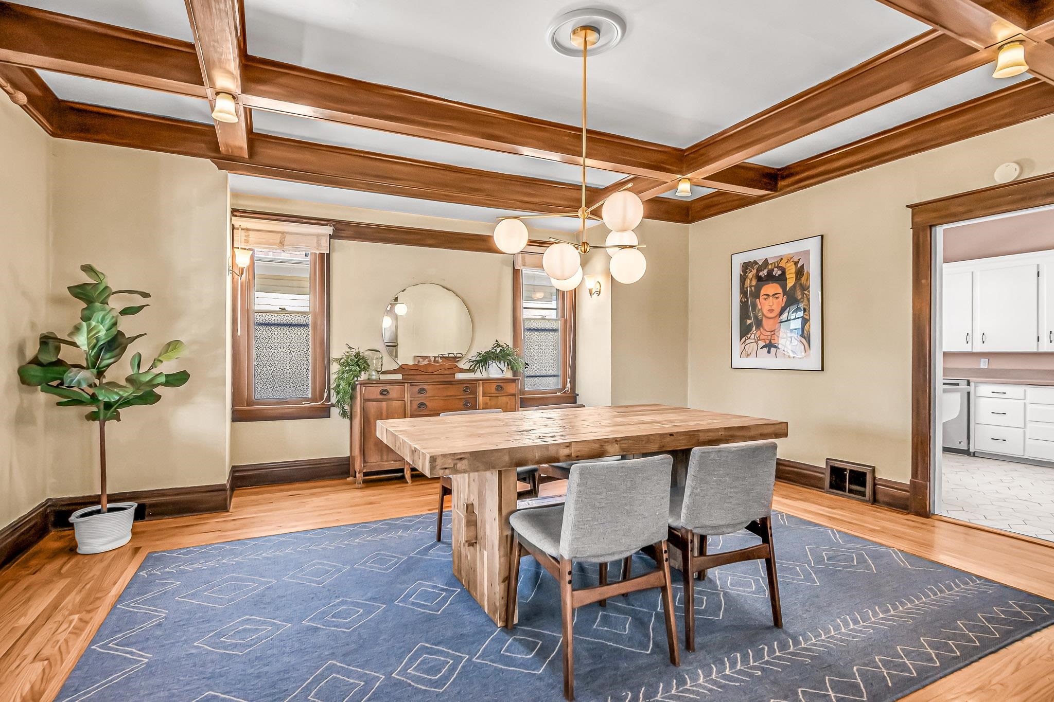 1244 Main Street Grand Junction, CO 81501 - Photo 13 of 33 a view of a dining room and livingroom with furniture wooden floor a chandelier and a rug
