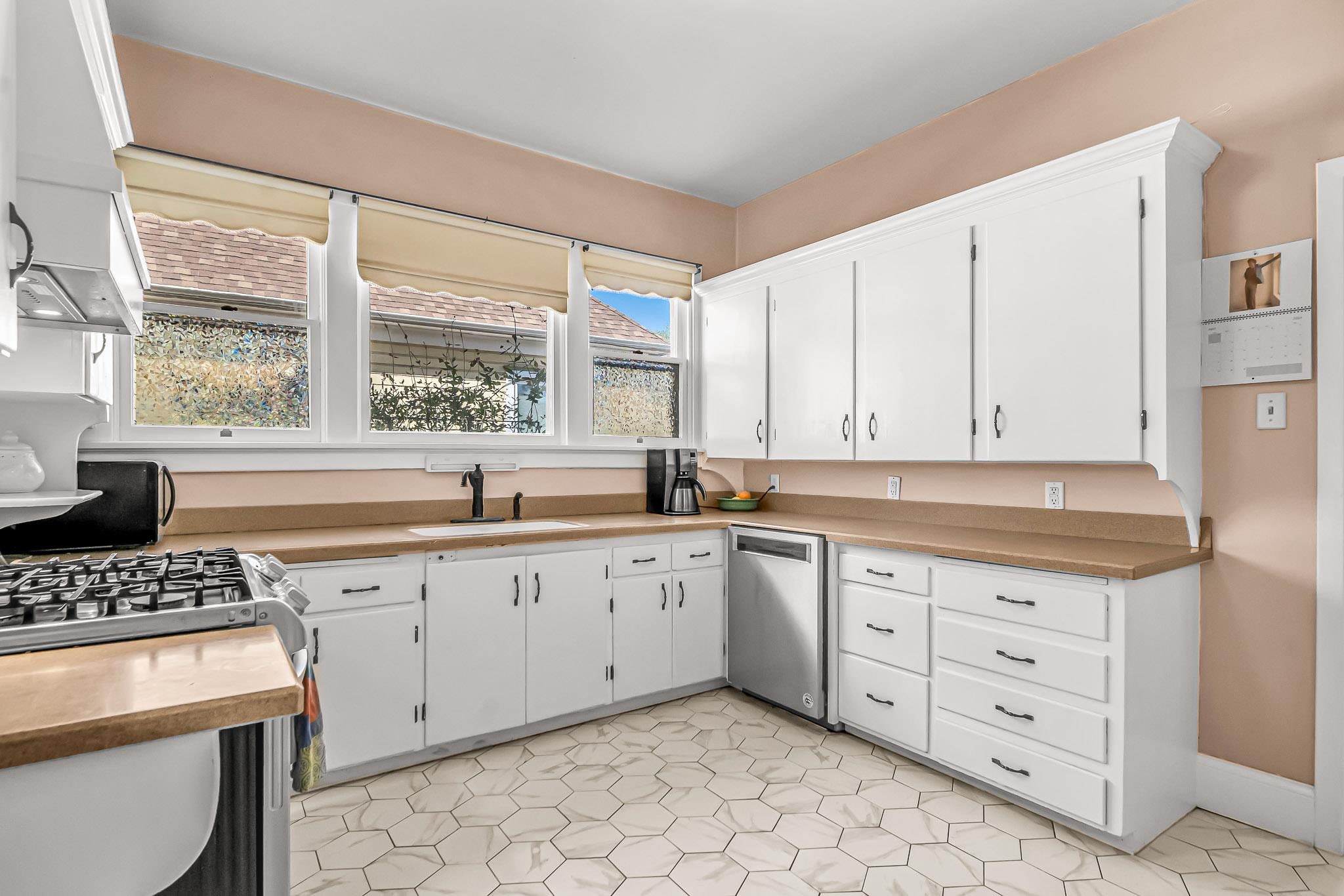 1244 Main Street Grand Junction, CO 81501 - Photo 14 of 33 a kitchen with granite countertop a sink a stove and cabinets