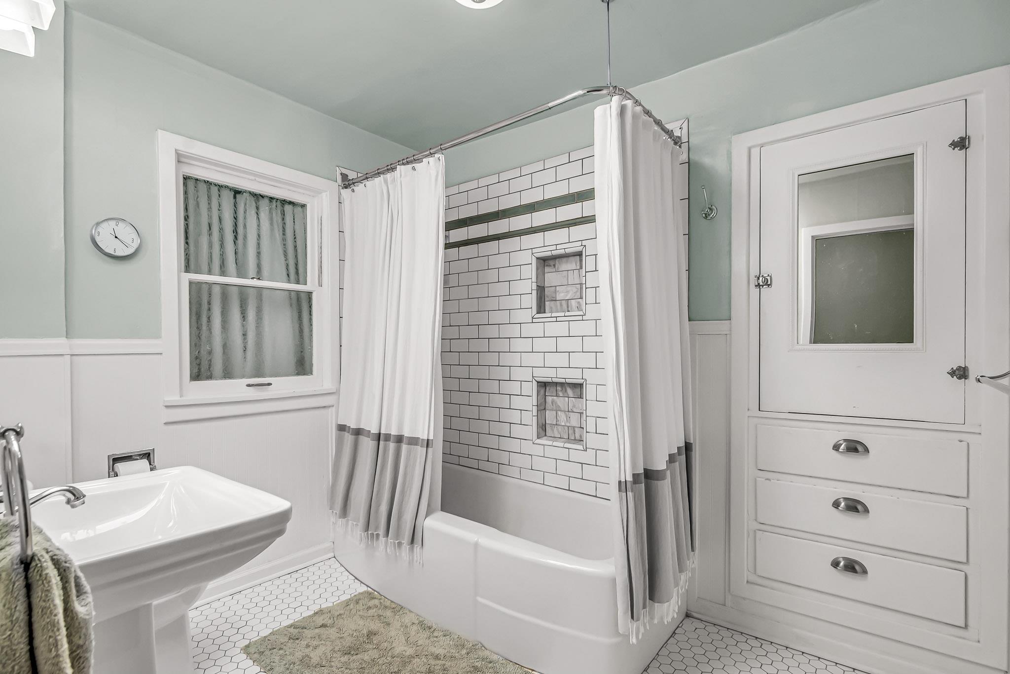1244 Main Street Grand Junction, CO 81501 - Photo 26 of 33 a bathroom with a tub sink and mirror