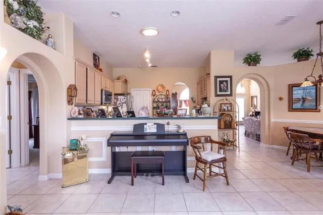 a view of a dining room with furniture and a kitchen