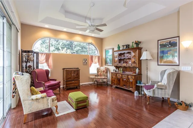a living room with furniture a fireplace and a large window
