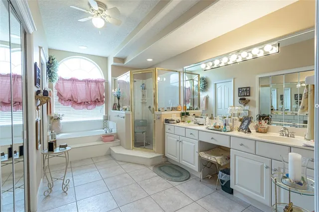a bathroom with a double vanity sink mirror and shower