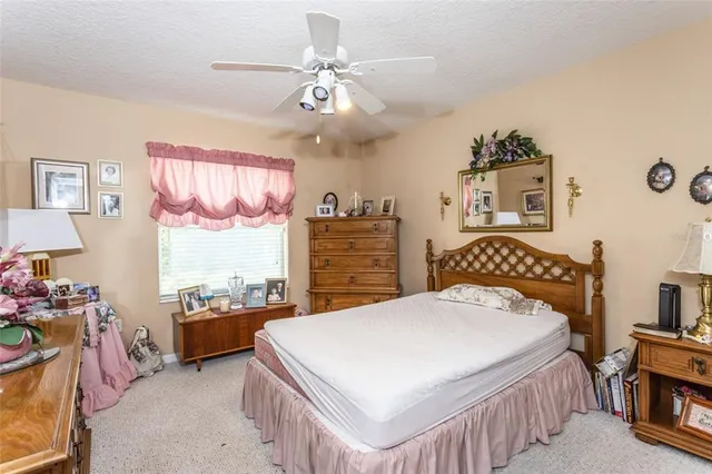 a bedroom with a bed a dresser next to a window