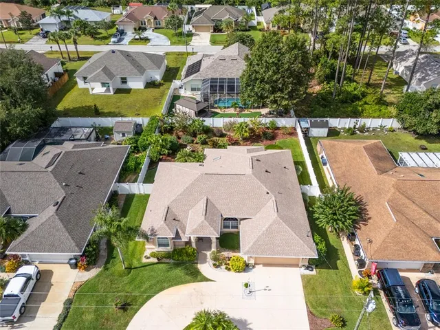 an aerial view of residential houses with outdoor space and parking