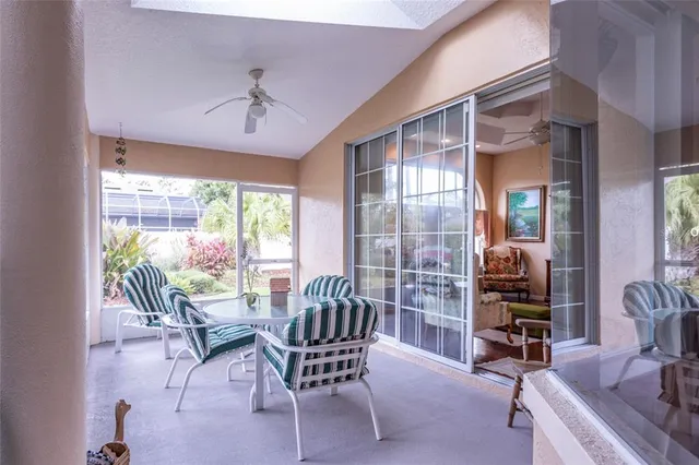 a dining room with furniture wooden floor and a chandelier
