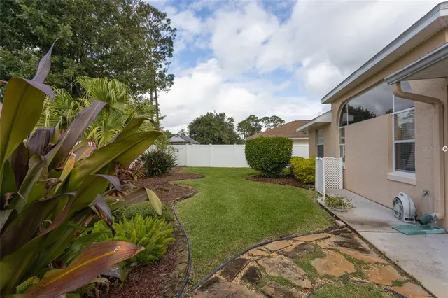 a view of a backyard with pathway
