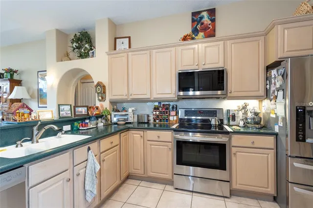 a kitchen with granite countertop a white cabinets and white appliances