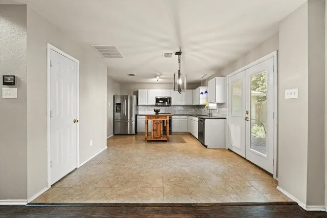 a large white kitchen with cabinets and a stainless steel appliances