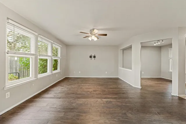 a view of a livingroom with furniture ceiling fan and window