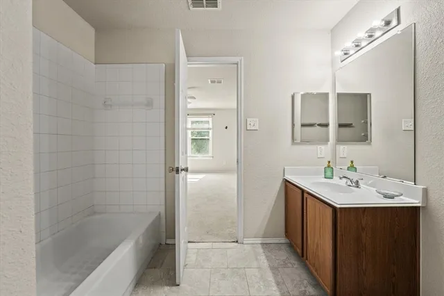a bathroom with a sink a shower and a mirror