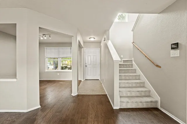 a view of entryway with stairs and wooden floor