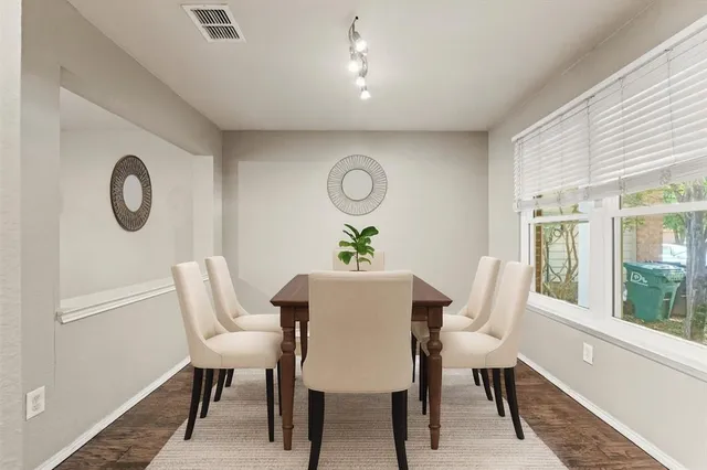 a view of a dining room with furniture window and wooden floor