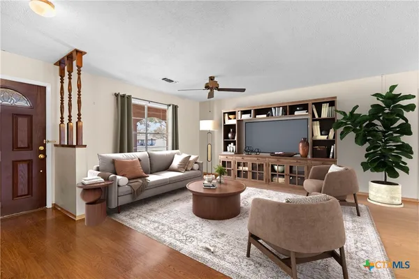 a living room with furniture and a flat screen tv