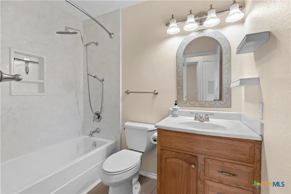 a bathroom with a sink a toilet and a mirror