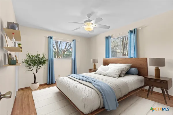a bedroom with a large bed and a chandelier