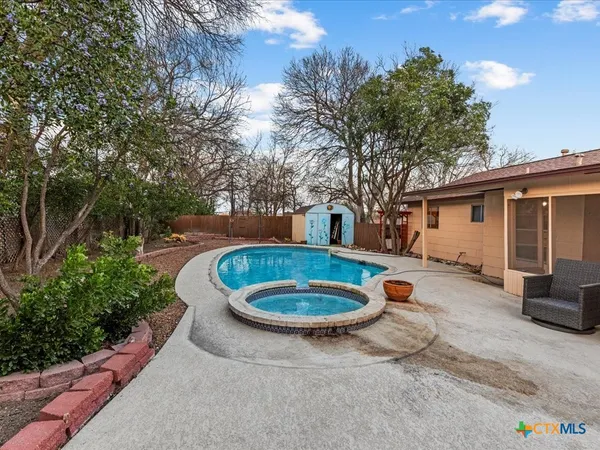 a view of a backyard with table and chairs and a fire pit