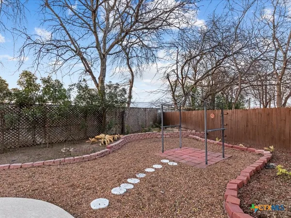 a backyard of a house with table and chairs