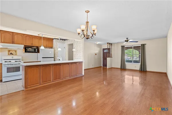 a view of a kitchen with a sink and a window