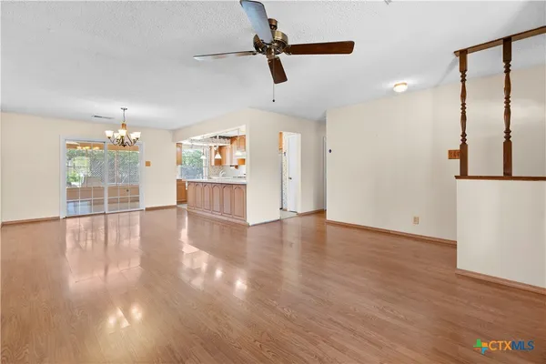 a view of a room with wooden floor and windows